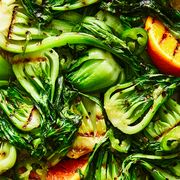 cooked bok choy with grill marks and orange halves