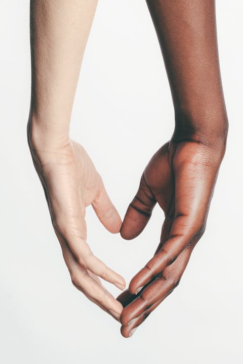 two hands touching to form a heart between them