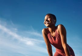 femme person smiling wearing workout clothes