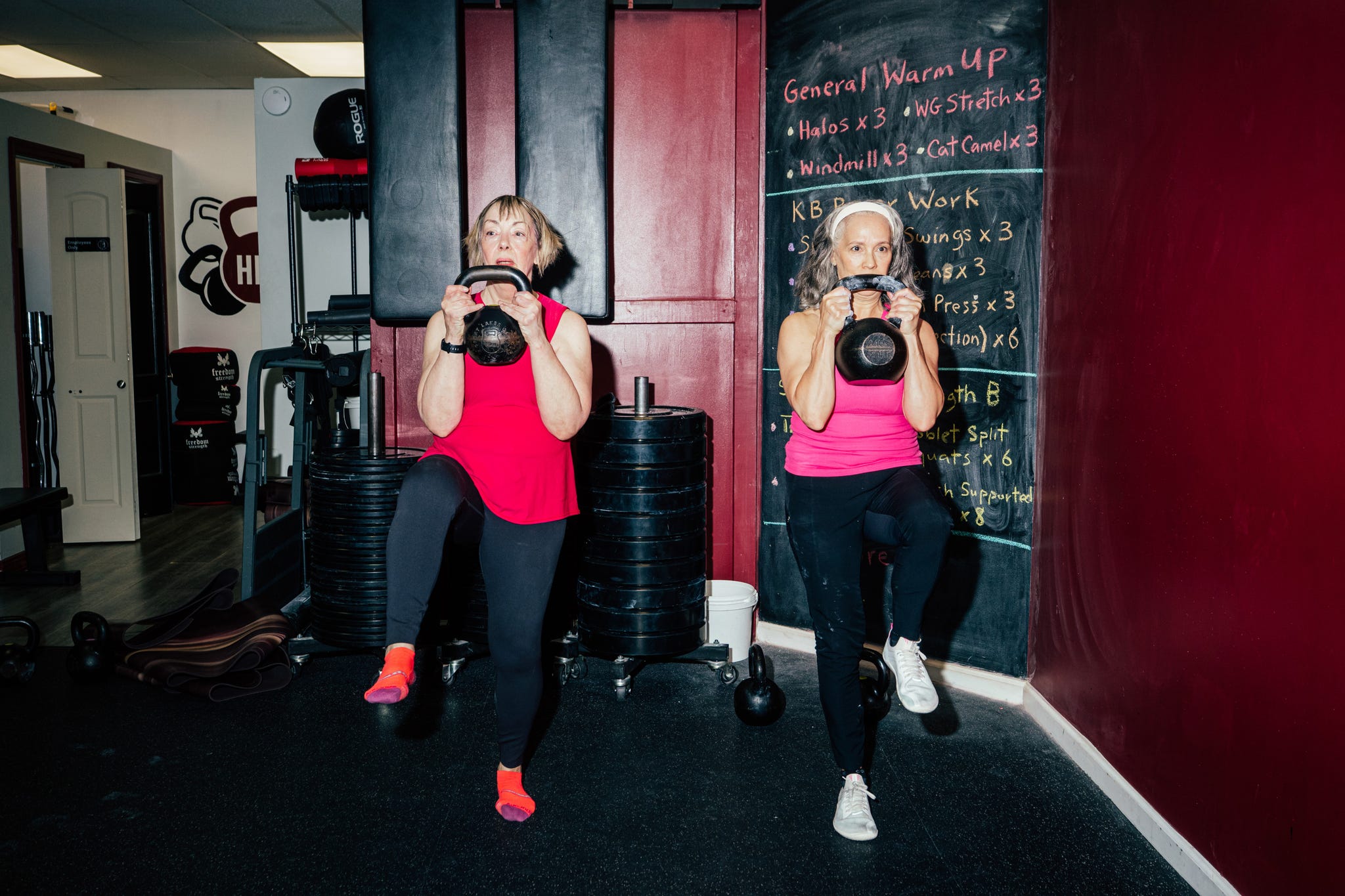 florence lynch (left) and heather jackson work on strength and stability in tandem at harlem kettlebell club in new york city.