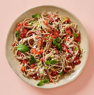 noodles covered in tomato sauce and herbs