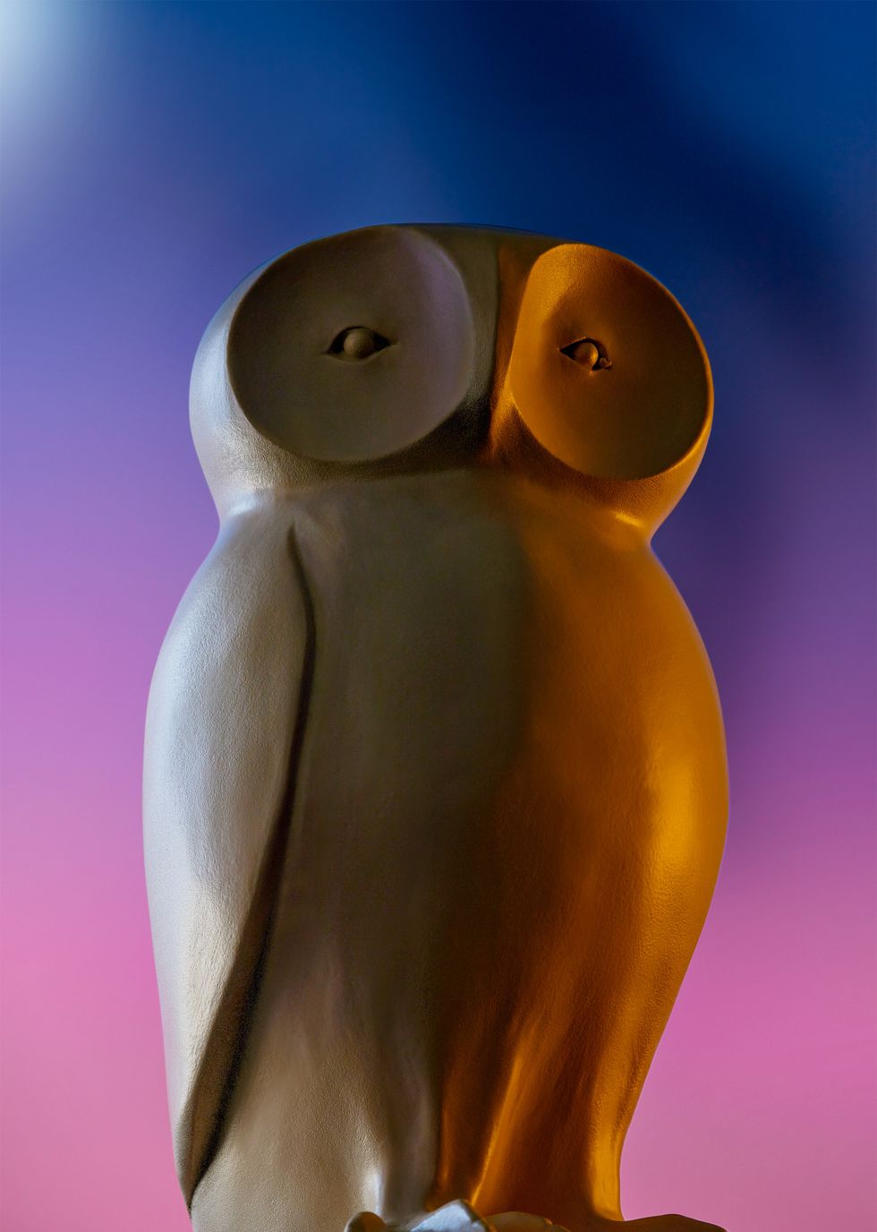 wooden owl on a purple blue background