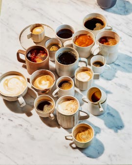 a group of coffee cups with liquid in them