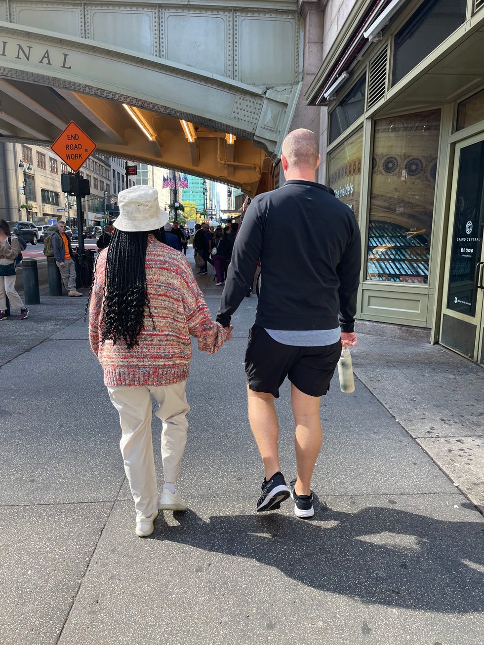couple holding hands walking away from camera
