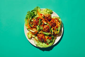 plate of lettuce wraps with meatballs and vegetables