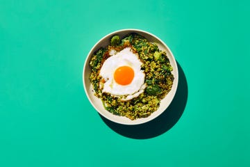 bowl of quinoa topped with a fried egg and greens