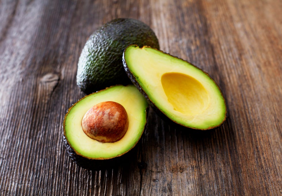 https://hips.hearstapps.com/hmg-prod/images/whole-and-sliced-avocado-on-wood-royalty-free-image-1581337443.jpg?crop=0.69471xw:1xh;center,top&resize=980:*