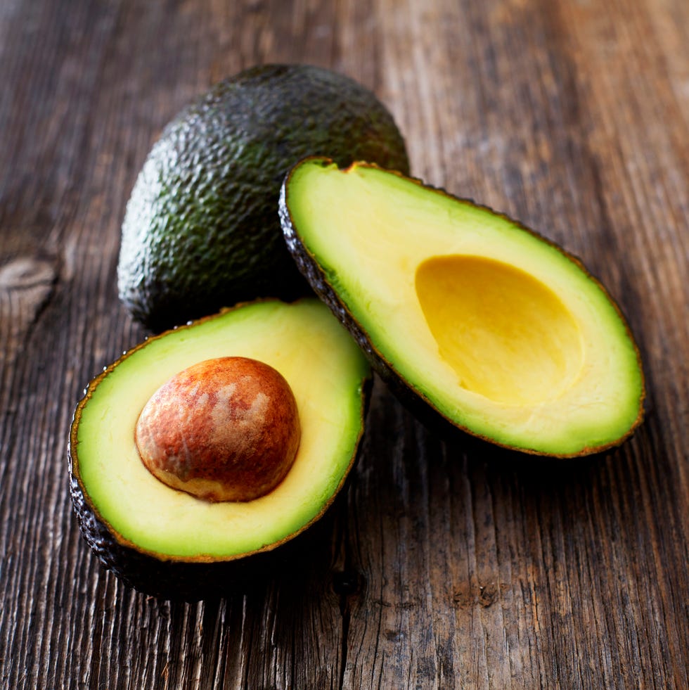 Whole and sliced avocado on wood whole and sliced avocado on wood