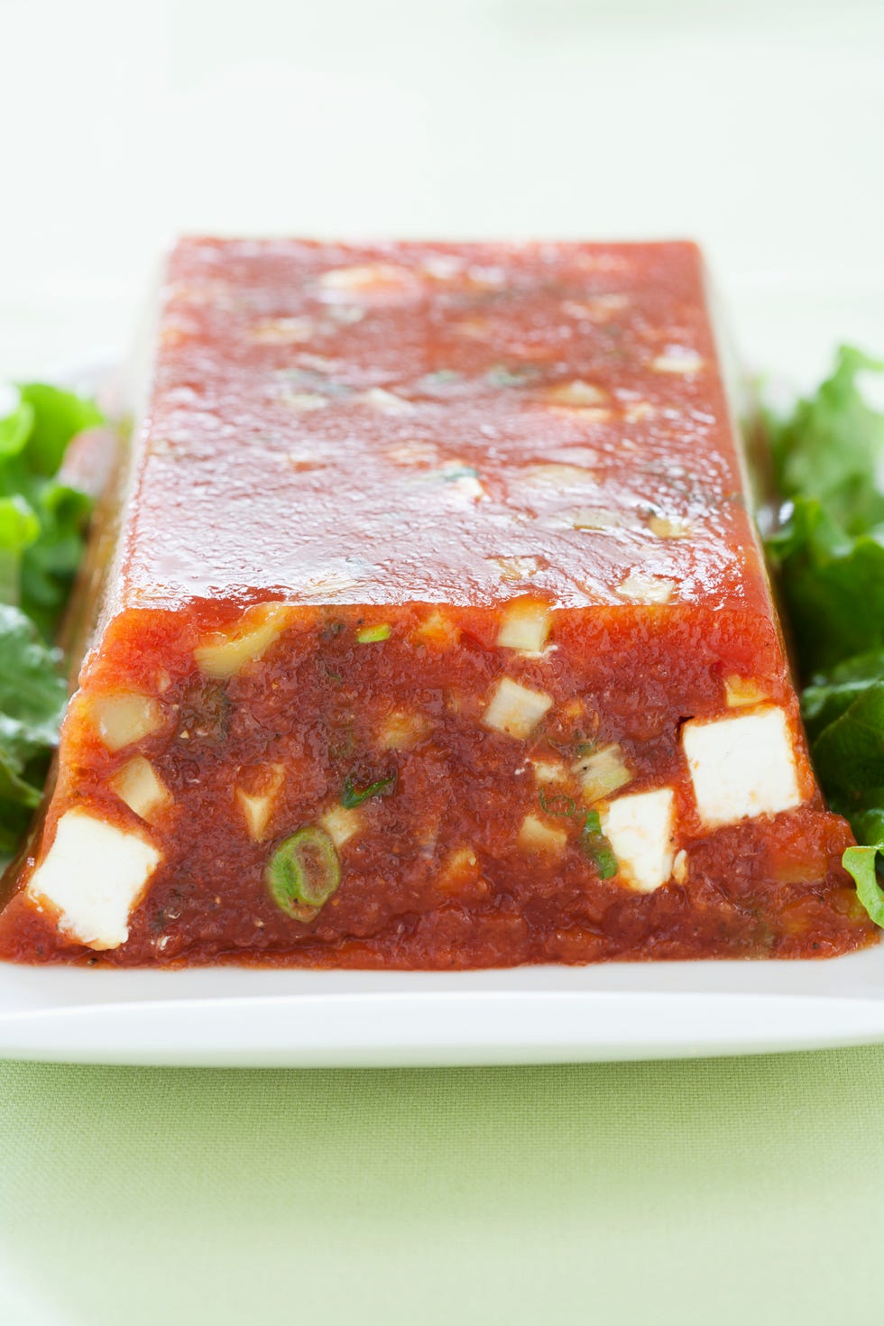 Whole tomato aspic in loaf shape on platter