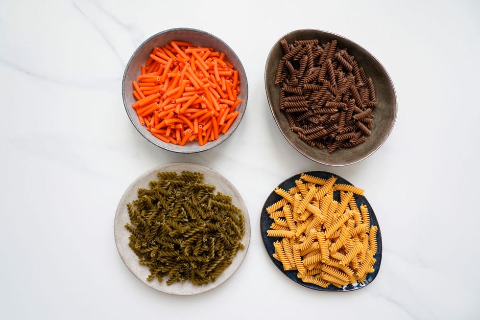 whole wheat pasta with buckwheat, red lentil flour, green pea flour, tuscan chickpea flour on a marble background, with space for text, italy, europe
