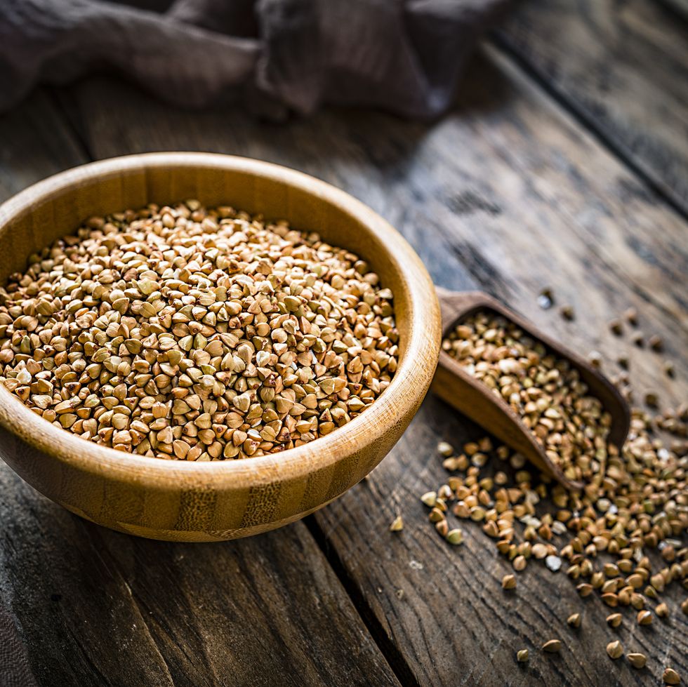 dietary fiber wholegrain buckwheat in a wooden bowl on rustic kitchen table