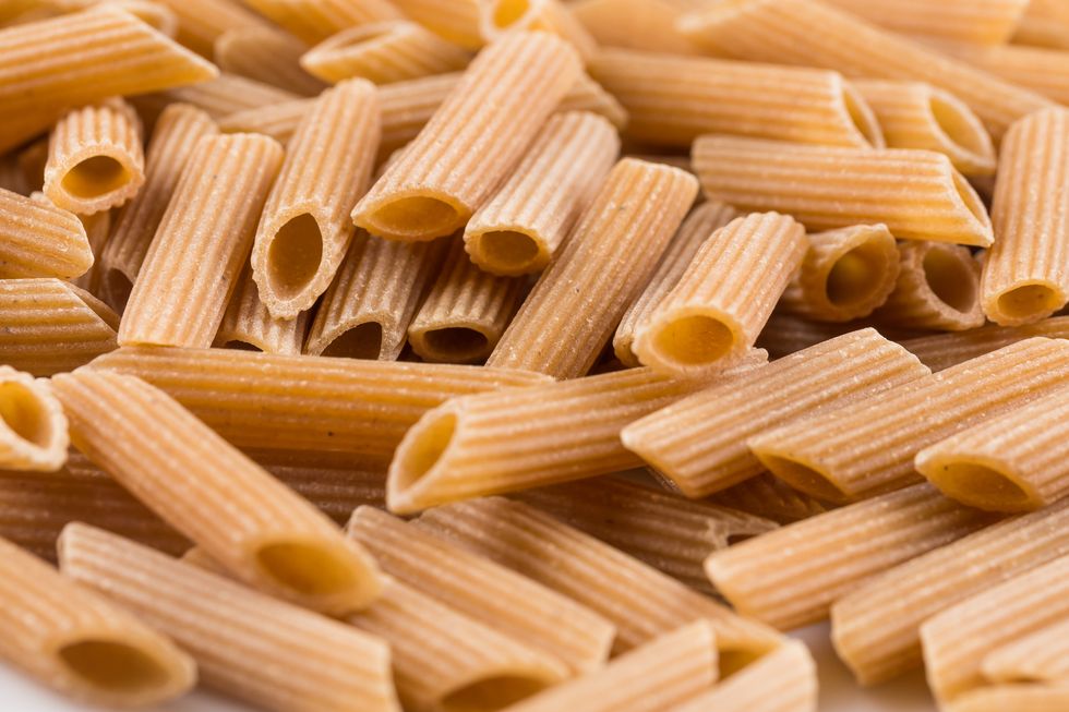 Wholemeal Pasta Penne as close-up shot for background
