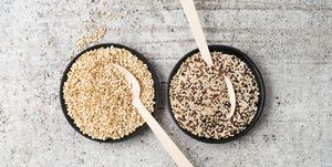 wholemeal quinoa and popped quinoa in bowls, wooden spoons