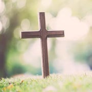 wooden cross in field of grass wooden cross in field of grass