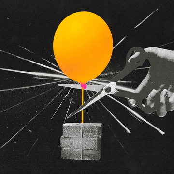 a balloon being cut from a pile of bricks