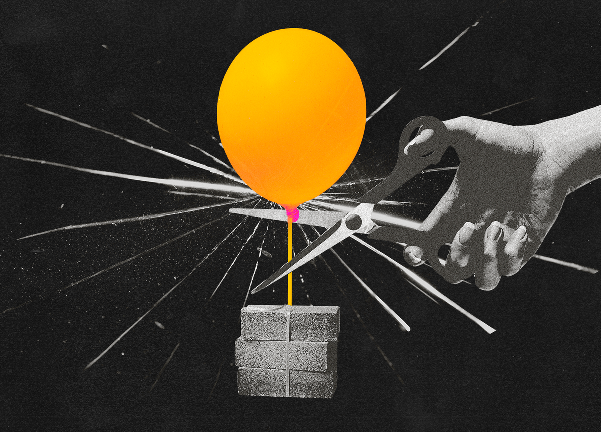 a balloon being cut from a pile of bricks