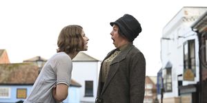 two women shout at each other in street in still from wicked little letters