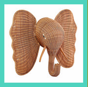 a wicker elephant head and a wicker tray with blue glasses