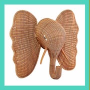 a wicker elephant head and a wicker tray with blue glasses a wicker elephant head and a wicker tray with blue glasses
