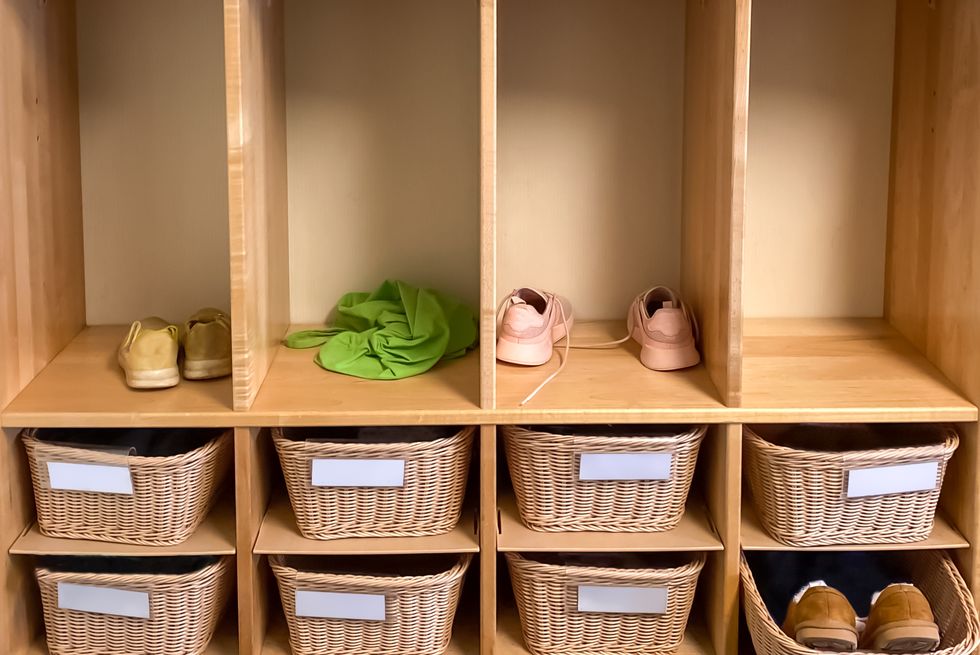 wicker basket storage cubbies & closets in preschool classroom with various belongings in view