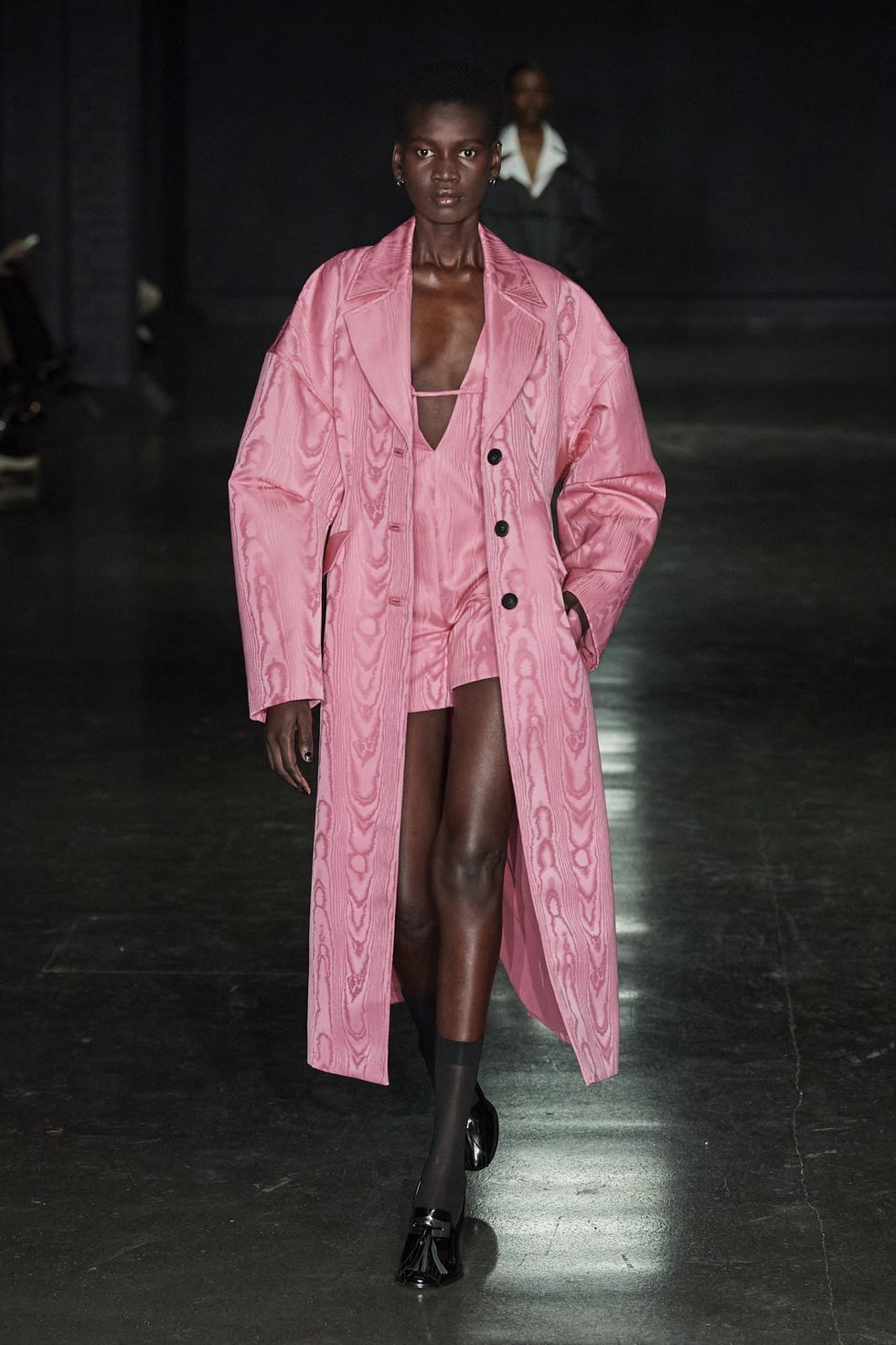 a model wearing a pink suit