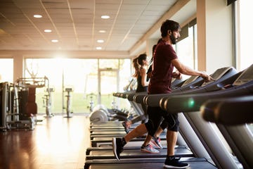 wide angle view of three people running at the treadmill