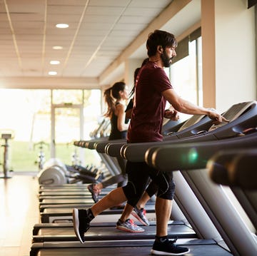 Wide-angle view of three people running at the treadmill. wide angle view of three people running at the treadmill