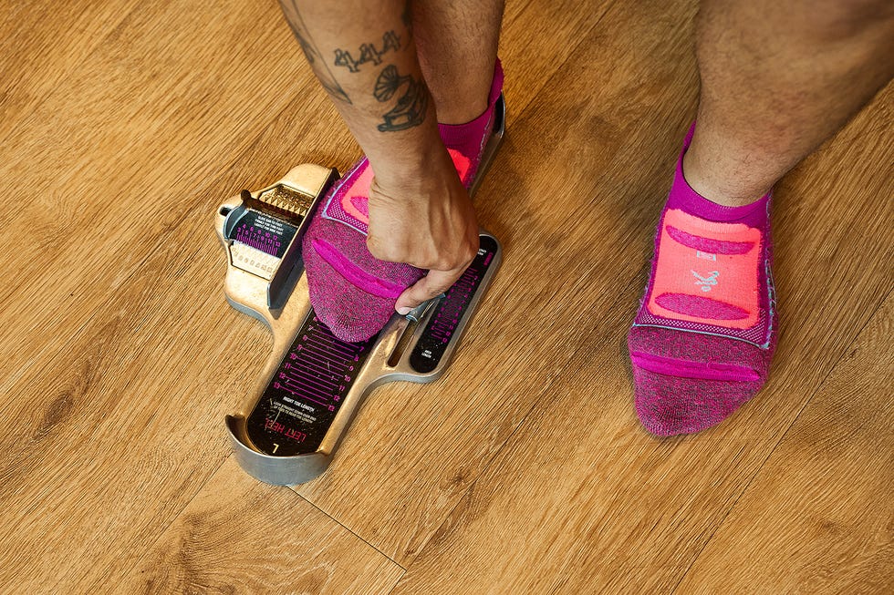 a person measuring their foot size and width