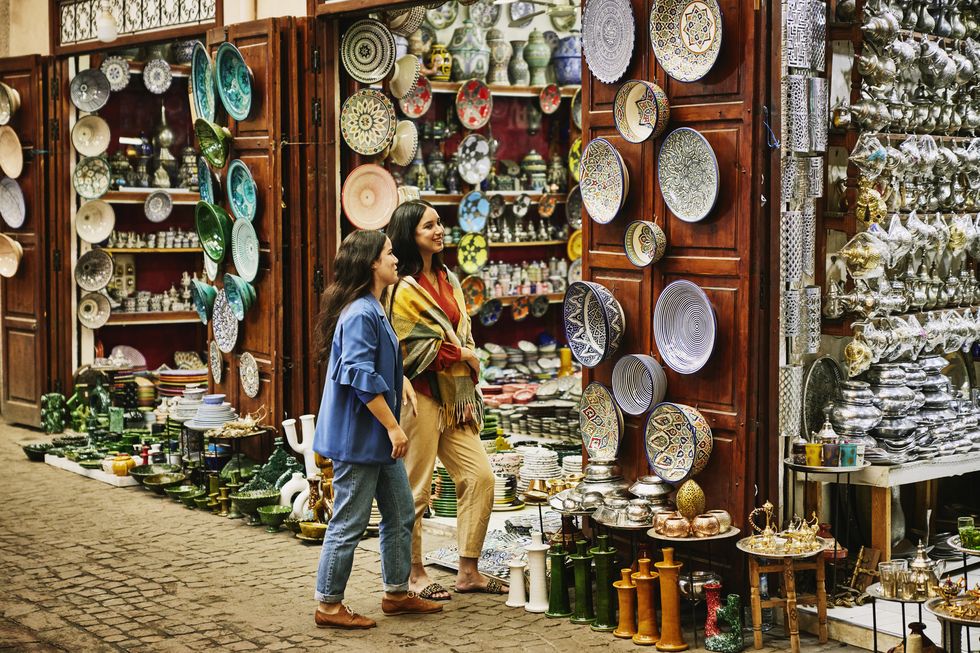 wide shot of friends exploring and shopping in the souks of marrakech