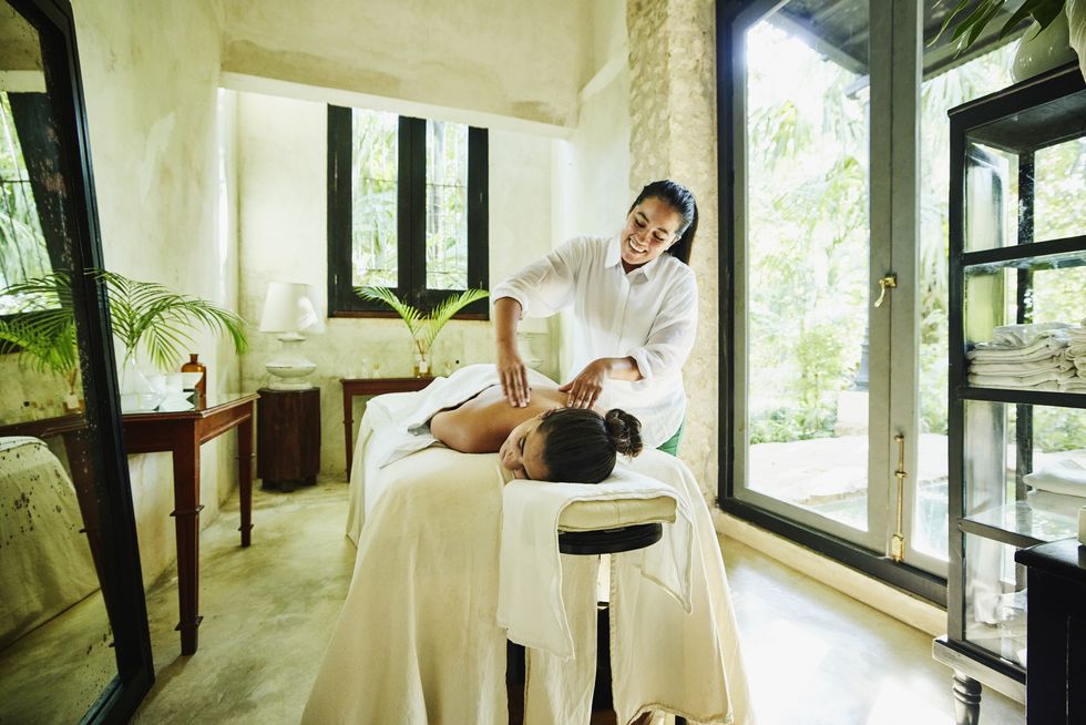 wide shot of woman receiving massage at luxury spa