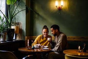 wide shot with copy space of couple sharing a dessert in cafe