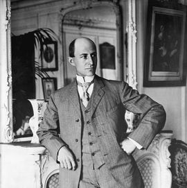 man leaning against a fireplace mantle