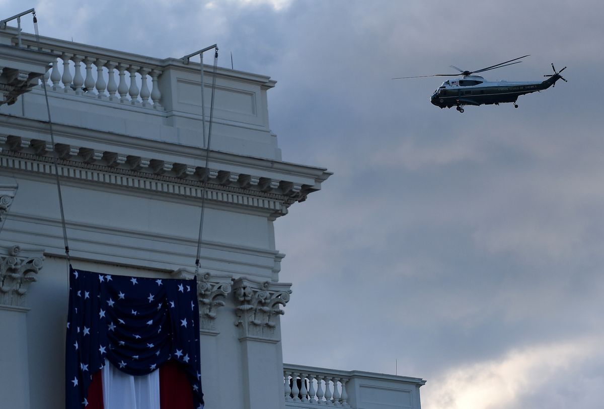 president trump onboard marine one flies by the 59th inaugural ceremony for president elect joe biden and vice president elect kamala harris at the us capitol on january 20, 2021 in washington, dc   president trump travels to his mar a lago golf club residence in palm beach, florida, and will not attend the inauguration for president elect joe biden photo by olivier douliery  afp photo by olivier doulieryafp via getty images