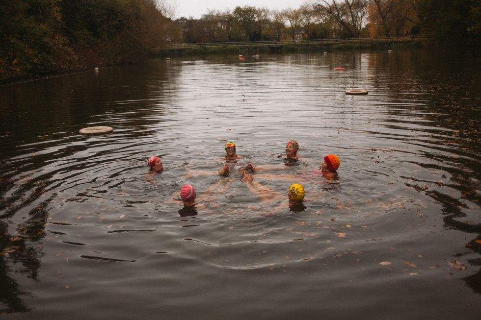 a wild swimming women's group take an autumnal swim
