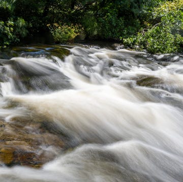 long exposure of a waterfall on the east lyn river flowing through the doone valley in exmoor national park