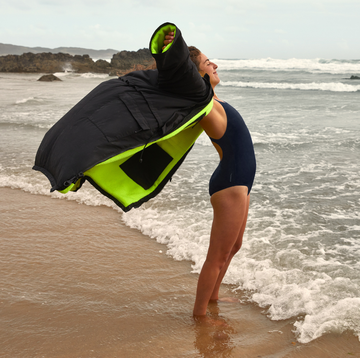 a person holding a life jacket on a beach