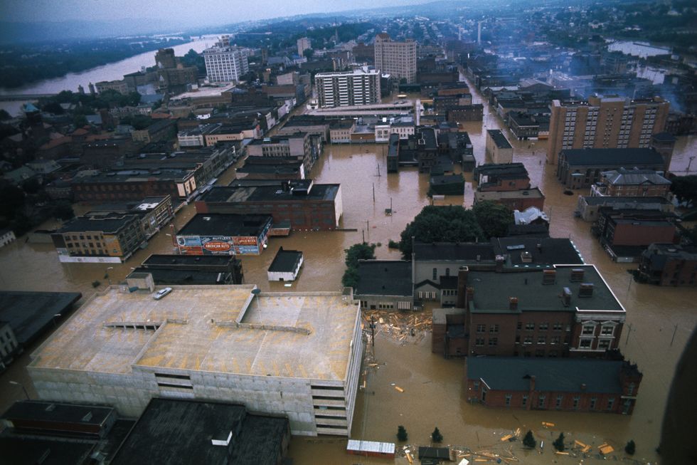 aerial view of a city with flooded streets and a river in the left upper corner of the frame
