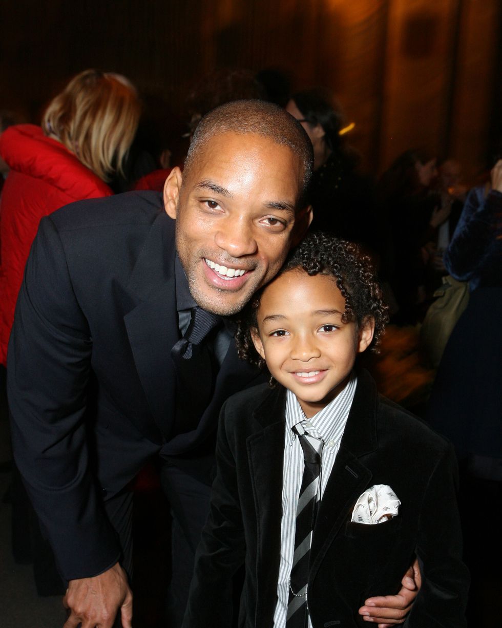 will smith and jaden smith smile at the camera, will leans down to his son