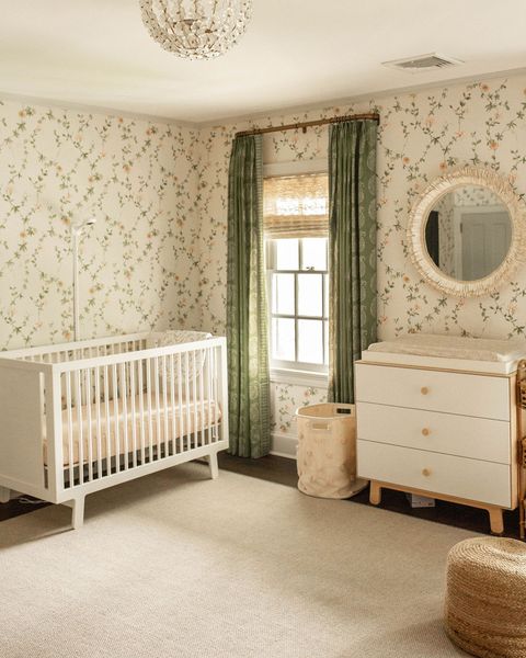 nursery, floral wallpaper, green curtains, white cot, white and wooden dresser, nude area rug