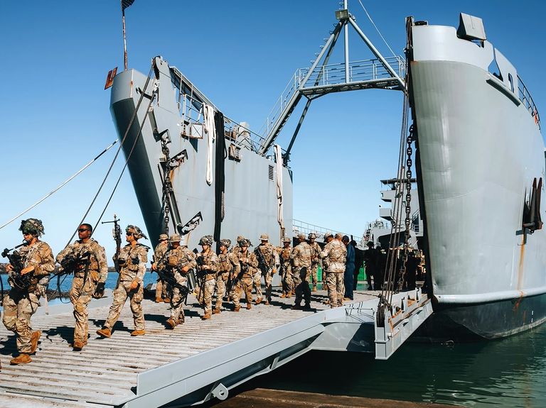 a group of army soldiers standing on a boat