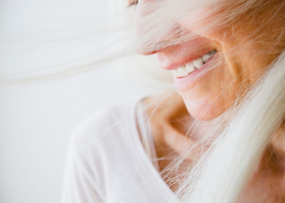 wind blown senior woman, smiling