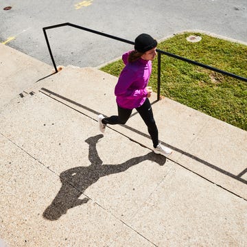 Person running along a sidewalk. person running along a sidewalk