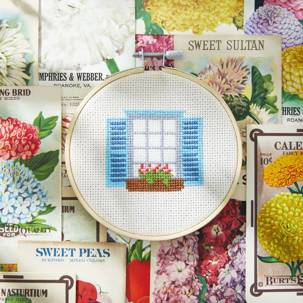 window box cross stitch on background of seed packets