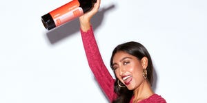 woman winking holding wine bottle