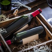 Wine bottles packed in a wooden box shot rustic wooden table