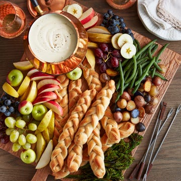 rustic cheese board with three cheese fondue and cable knit breadsticks