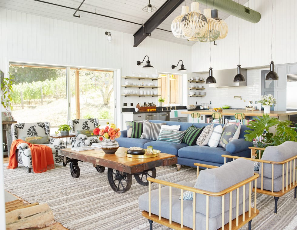 casual california family room with blue sofa and factory cart turned coffee table