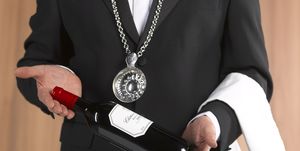 wine waiter sommelier presenting bottle of wine
