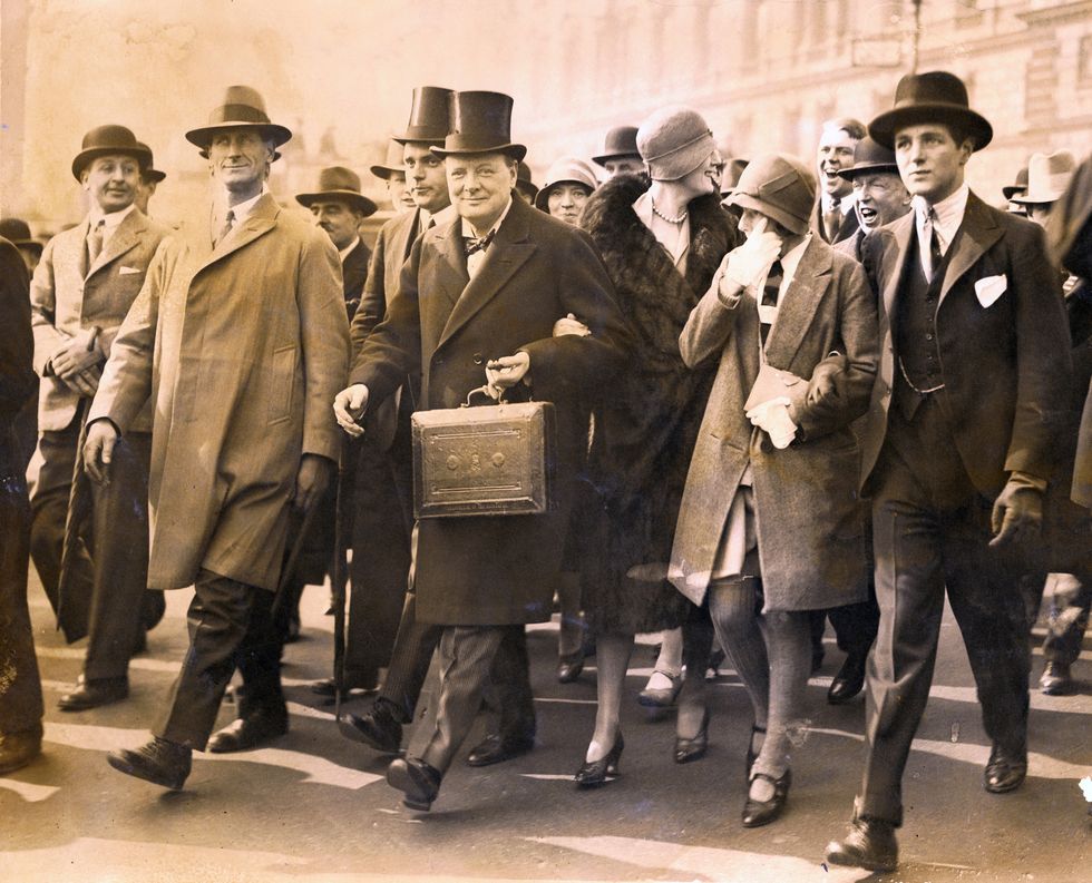 winston churchill, chancellor of the exchequer, carries the dispatch box on his way to the house of commons, in london, to present the budget, april 29, 1929