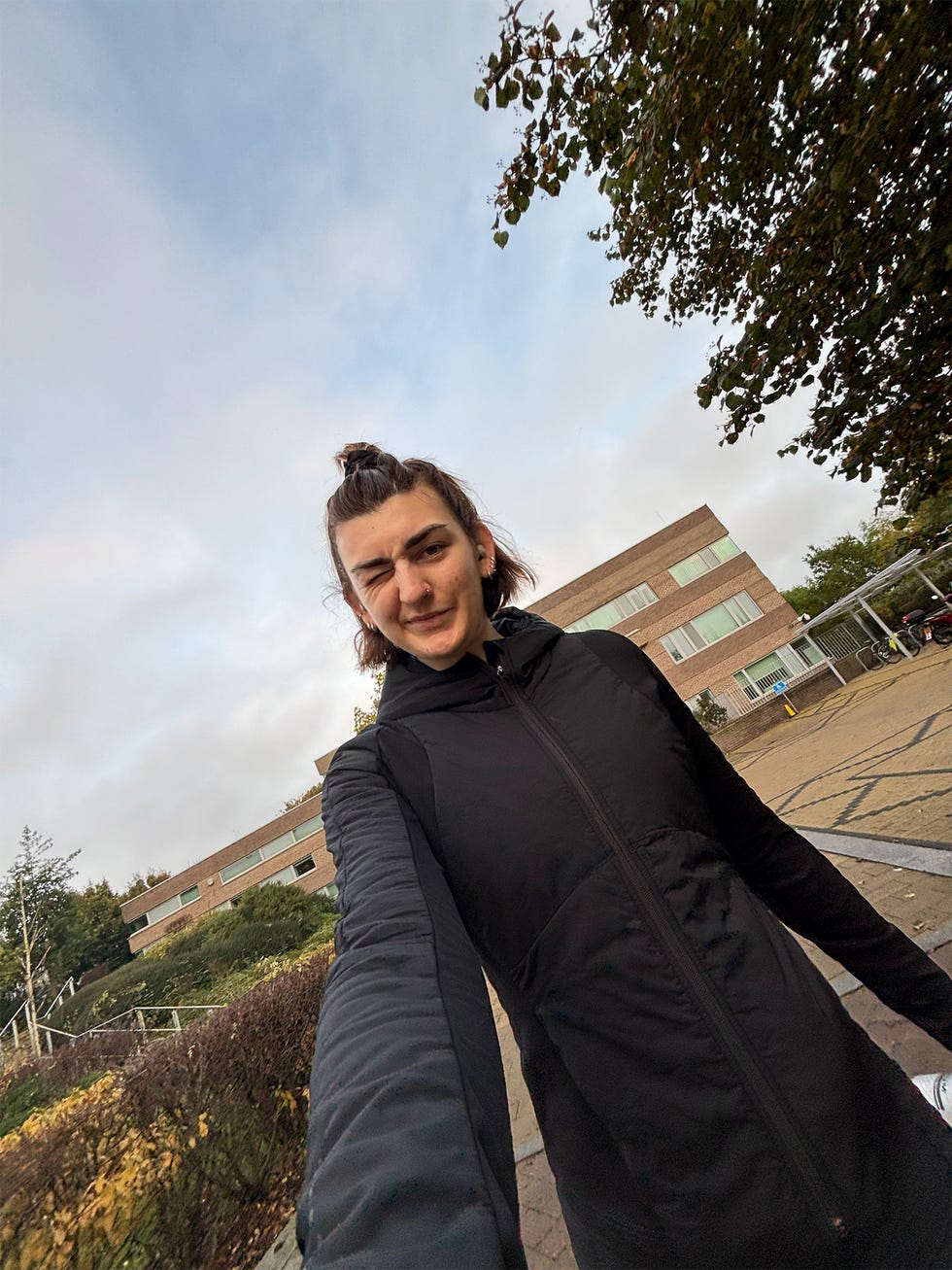 person taking a selfie outdoors near a building